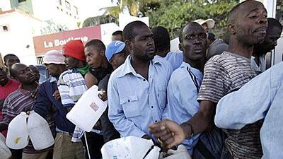 People queue for petrol in Port-au-Prince. The UN and other aid agencies are continuing to struggle to get supplies to survivors of Tuesday's quake.
