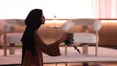 A pro-Palestinian demonstrator holds a kufiyyeh as she interrupts Microsoft AI chief executive Mustafa Suleyman during a presentation of the company's AI assistant, Copilot, at Microsoft headquarters. AP