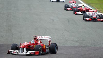 Fernando Alonso leads a pack of four at the Silverstone race track in Northamptonshire.