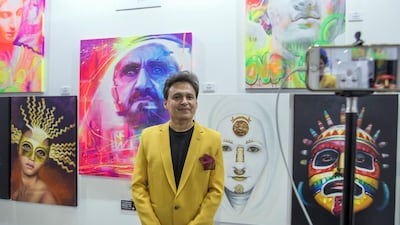 Artist Coco Valdez with his augmented artworks at the World Art Dubai at Dubai World Trade Centre. Leslie Pableo / The National