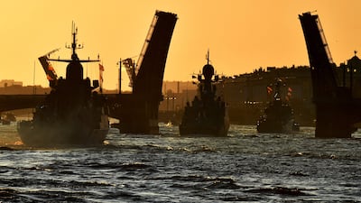 Russian warships sail on the Neva river during a rehearsal for the Naval parade in Saint Petersburg on Sunday. AFP
