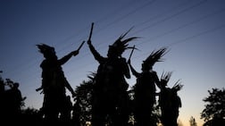 Traditional dancers perform near Hook in Hampshire, England, as they see in the May Day dawn. Photo: PA