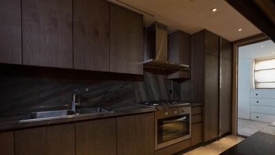 The kitchen features dark wood and stainless steel.