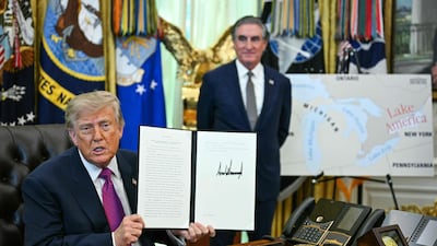 President Donald Trump, with Interior Secretary Doug Burgum, holds up the executive order he signed to rename Lake Ontario. AFP