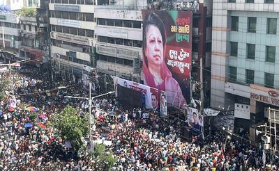 Supporters of the Bangladesh Nationalist Party attend a mass rally in Dhaka. A picture of imprisoned BNP party chairwoman Khaleda Zia is displayed. EPA