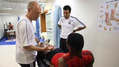Nick Worth, director of Medical Services for Al Jazira, talks with one of the players in the tape room prior to practice at Mohammed Bin Zayed Stadium. Worth has been trying to introduce the team to a more nutritional meal plan.