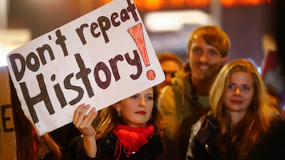 A warning from a demonstrator in a protest against the anti-immigration party Alternative fuer Deutschland (AfD) after the German general election in Berlin, Germany, September 24, 2017. Hannibal Hanschke /Reuters