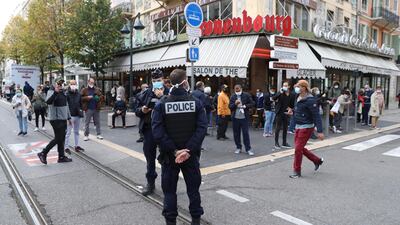 French policemen stand guard on the street after a knife attack in Nice. AFP