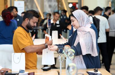 A customer receiving his iPhone 17 Pro Max at the Apple Store in The Dubai Mall. Chris Whiteoak / The National
