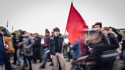 Remi Faussemagne, a 22 year old, student and cashier, poses for a photograph during the annual May Day workers' rally in Paris. AFP/LUCAS BARIOULET