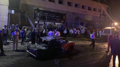 People look on at the damage left by a fire from a blast at the National Cancer Institute, Cairo, Egypt. EPA