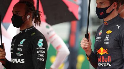 Mercedes' British driver Lewis Hamilton (L) stands next to Red Bull's Dutch driver Max Verstappen ahead of the Hungarian Grand Prix. AFP
