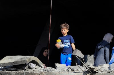 A Palestinian boy inspects the damage at the site of an Israeli strike in Gaza city. Reuters