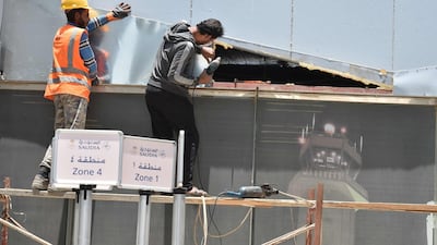 Workers fixing the damage at Abha airport. AFP