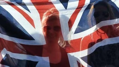 Tennis fans hold up a Union flag at Murray Mount. Ben Stansall / AFP