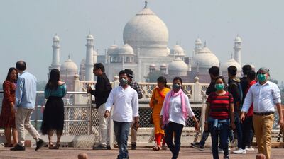 Tourists wear face masks as a preventive measure against the spread of the COVID-19 coronavirus outbreak, near Taj Mahal in Agra on March 5, 2020. But the monument is now closed. AFP