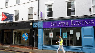 A man walks past a closed shop in Nottingham as the English city entered the highest level of lockdown on Friday. Bloomberg