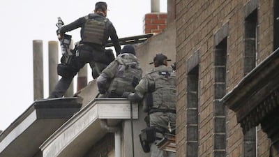 Belgian special forces climb an apartment block in the Brussels suburb of Molenbeek during a raid on November 16, 2015, in search suspects linked to the deadly attacks in Paris. Bassam Ayachi was imam at the suburb's Belgium Islamic Center.