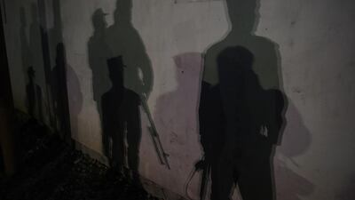 The shadows of Afghan police officers are seen near the site of an attack on the Spanish embassy compound in Kabul. Insurgents have launched an attack on a Spanish embassy compound in Kabul, Afghan officials said, following reports of gunfire and a massive car bomb in the centre of the city. Shah Marai / AFP