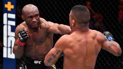 Kamaru Usman, left, punches Gilbert Burns of Brazil in their UFC welterweight championship fight during the UFC 258 event at UFC APEX on February 13, 2021 in Las Vegas, Nevada. Jeff Bottari / Zuffa LLC / Getty Images