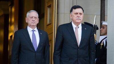 Jim Mattis, left, and Libyan prime minister Fayez Serraj stand for the Libyan National Anthem before meeting at the Pentagon. AP Photo/Cliff Owen