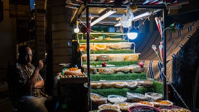 A snack vendor waits for customers in Baghdad. Iraq's non-oil gross domestic product is expected to have moderated to 2.5 per cent in 2024, the IMF said. AFP