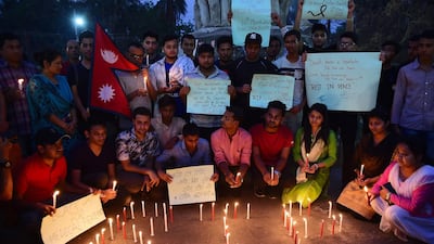 Nepali students, who study in Bangladesh, take part in a candlelight vigil in honour of the Kathmandu plane crash victims. Munir Uz Zaman / AFP