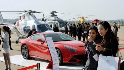 A Ferrari and helicopters on static display at the aviation show in Shanghai Hongqiao international airport. Mark Ralston / AFP