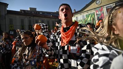 A participant shoults as he prepares to throw an orange. AFP