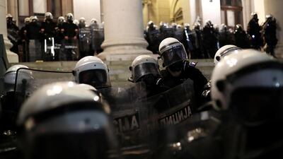 Riot police stand in formation outside the parliament building in Belgrade, Serbia, on Friday. Reuters