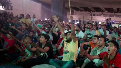 Egyptian fans watch the World Cup on a giant screen at Al Jazeera youth club in Cairo. AP