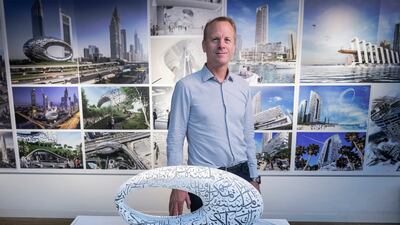 Shaun Killa, the architect who designed Dubai's Museum of the Future, with a model of the museum at his Killa Design offices in Dubai. Antonie Robertson / The National