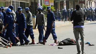 A woman lies in the road after being injured by police. AP Photo