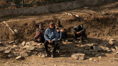 Locals at Gulmarg, Kashmir, are idle as few tourists visit the ski resort because no snow has fallen. Wasim Nabi for The National