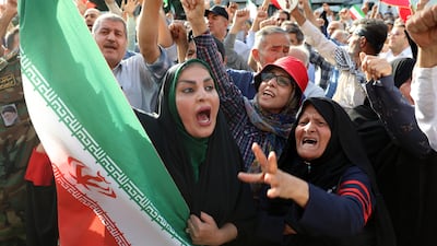 A woman holds an Iranian flag at an anti-US and anti-Israel demonstration in Tehran, Iran. EPA