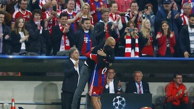 Bayern Munich player Thiago Alcantara hugs manager Pep Guardiola during their Champions League quarter-final second leg victory over FC Porto on Tuesday. Michael Dalder / Reuters / April 21, 2015