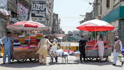 Vendors standing near their stalls wait for customers in front of a market sealed by authorities as a preventive measure against the coronavirus in Rawalpindi. AFP