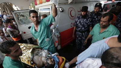 File picture of Palestinian medics pushing a wounded man injured from an Israeli strike in Shujaieh neighbourhood, into the emergency room at Gaza City’s Shifa hospital taken on July 30, 2014 during the summer war. Lefteris Pitarakis/AP Photo