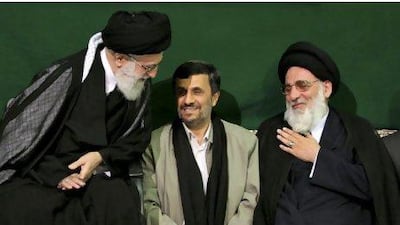 The Iranian supreme leader Ayatollah Ali Khamenei, left, greets former Judiciary chief Ayatollah Mahmoud Hashemi Shahroudi, right, as President Mahmoud Ahmadinejad, centre, sits during a religious ceremony in Tehran. AP Photo/Office of the Supreme Leader