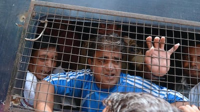 Unidentified convicted Indian men look out from a police vehicle after a verdict in the 2002 Gujarat riot massacre in Ahmedabad on June 2, 2016. A special Indian court convicted two dozen Hindus on June 2 over a massacre during religious riots 14 years ago when prime minister Narendra Modi was chief minister of Gujarat state. Sam Panthaky/AFP