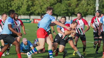 UAE, in red and white, in action against the Conference Barbarians on Friday. Victor Besa for The National