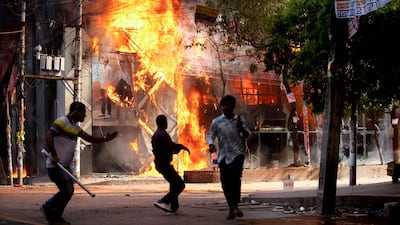 A garment store is set ablaze in Dhaka on Sunday during a protest against job quotas. AFP