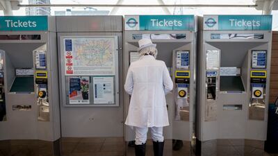 An MCM Comic Con cosplayer buys a tube ticket. EPA