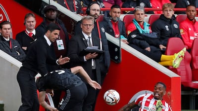 Arsenal manager Mikel Arteta reacts as Kieran Tierney and Brentford's Ivan Toney crash off of the pitch. AFP