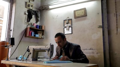 Ali Sarsour uses a sewing machine at his home in Amman. Reuters