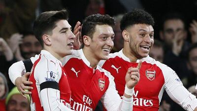 From left to right, Hector Bellerin, Mesut Ozil and Alex Oxlade-Chamberlain celebrate a goal against Bournemouth on Monday night. Stefan Wermuth / Reuters / December 28, 2015