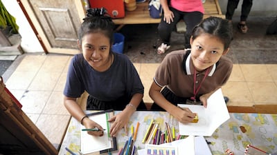 Two students come together to draw. Sasamon Rattanalangkarn for The National