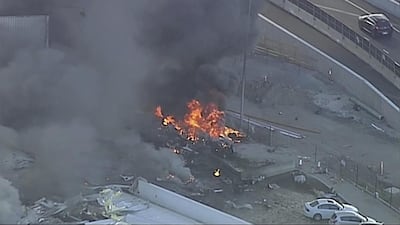 Flames at the site of the plane crash. Channel 9 via AP