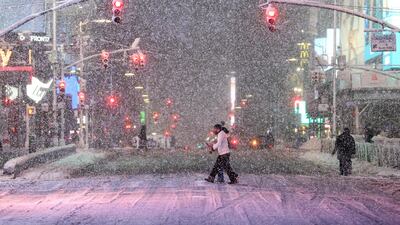 Braving heavy snowfall in Times Square, Manhattan, during a snowfall in New York City. A storm threatened to lay down 30cm of snow across the US East Coast beginning on Sunday, February 22. AFP