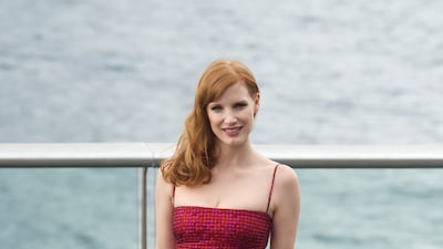 Jessica Chastain, in a crimson lace dress, attends a photocall for 'The Disappearance of Eleanor Rigby' crew during the 62nd San Sebastian International Film Festival on September 23, 2014 in Spain. Getty Images